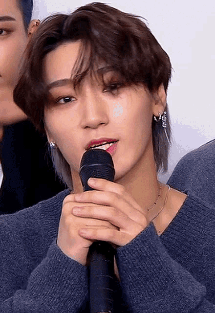 a close up of a person holding a microphone in their hands
