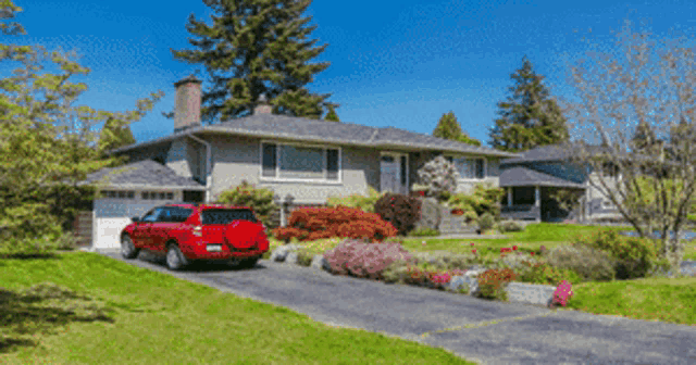 a woman is using a lawn mower to cut the grass in her yard .