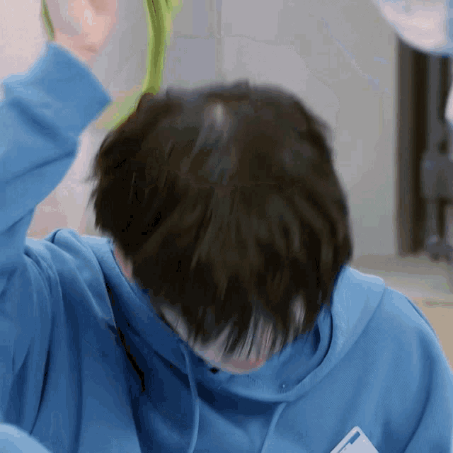 a person wearing a blue hoodie has a name tag that says ' a ' on it