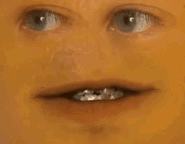 a close up of a person 's face with their mouth open and their eyes closed .