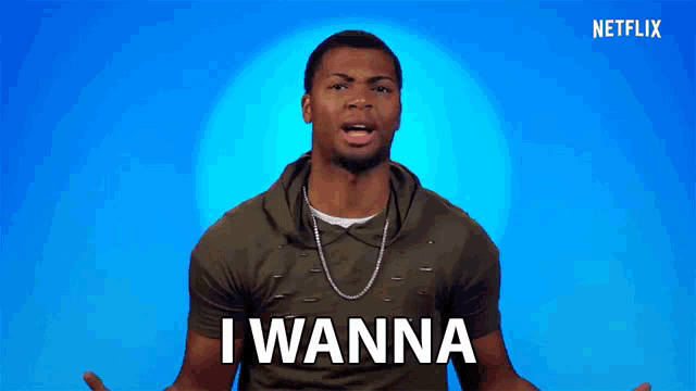 a man in a green shirt says i wanna in front of a blue background