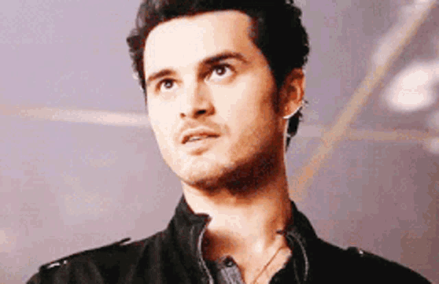 a close up of a man 's face with a serious look on his face .