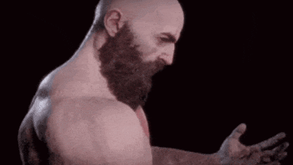 a bald man with a beard is standing in front of a black background with his hand outstretched .