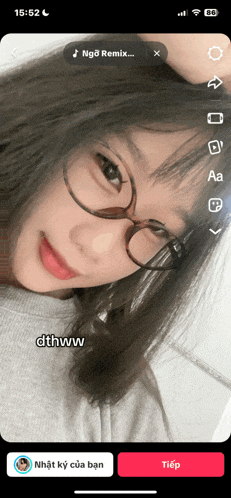 a phone screen shows a girl wearing glasses and the words dthww on the bottom