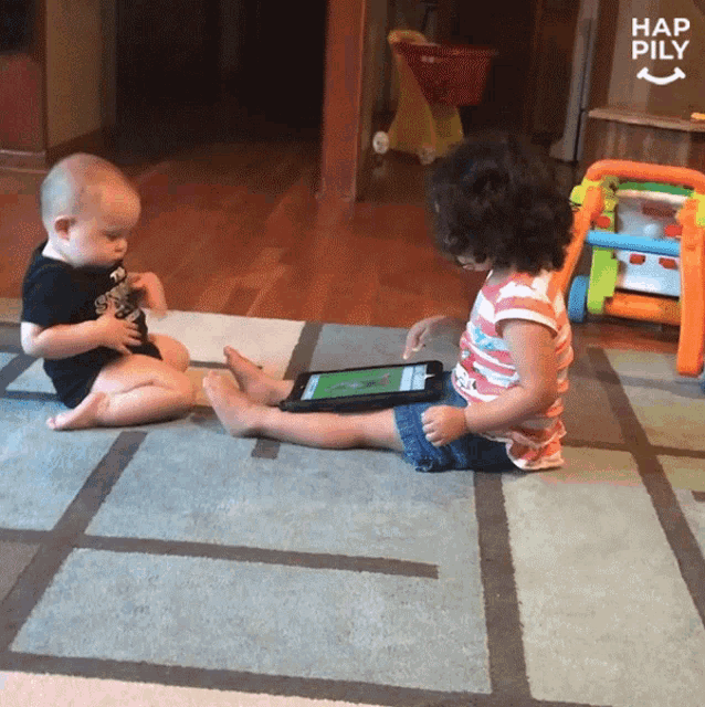 a boy and a girl sitting on a rug with a sign that says hap pily in the background