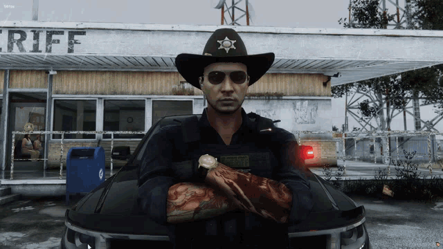 a man wearing a cowboy hat and sunglasses stands in front of a building that says sheriff