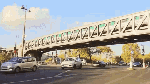 cars are driving under a bridge that has the letters zz on it