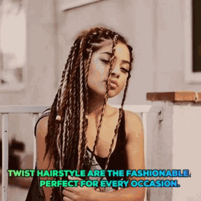a woman with twisted hair is sitting on a railing with a quote .