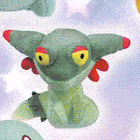a close up of a stuffed animal with yellow eyes and red ears