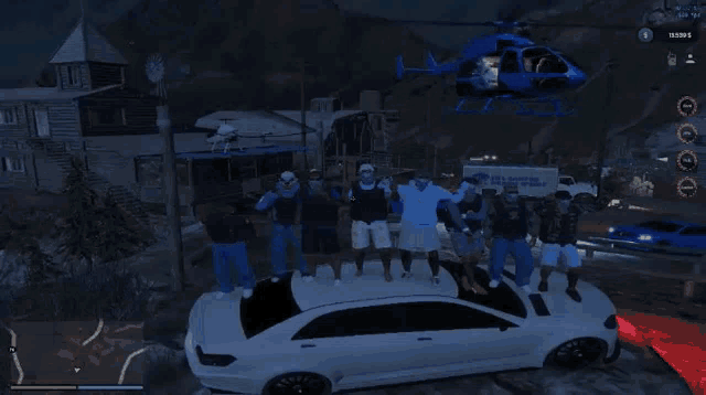 a group of people standing on top of a car in front of a helicopter