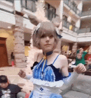 a woman in a bunny costume is dancing in a room with people .