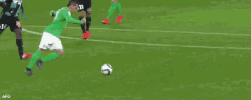 a soccer game is being played in front of a large sign that says la ch