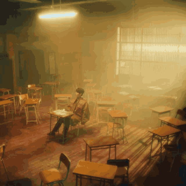 a man sits at a desk in a classroom with smoke coming out of the ceiling