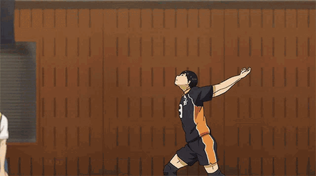 a volleyball player with the number 9 on his jersey is jumping in the air
