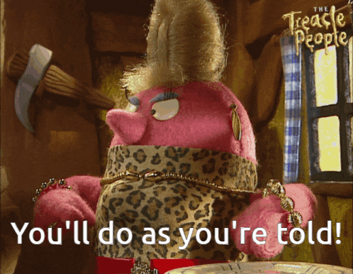a pink stuffed animal with the words you 'll do as you 're told on the bottom