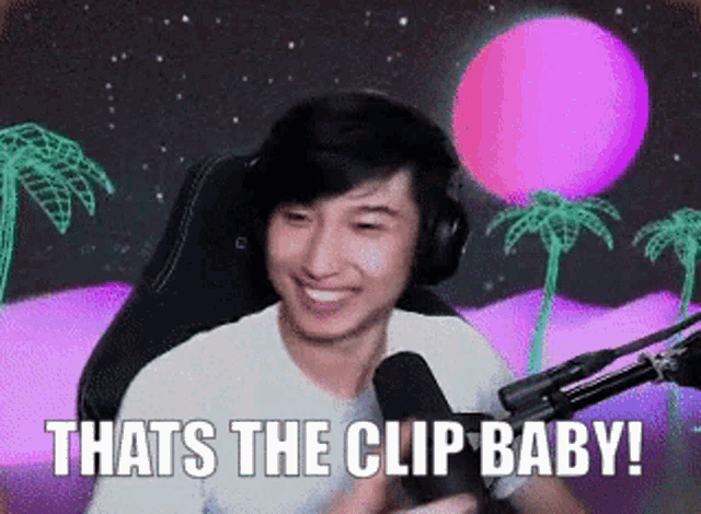 a man sitting in front of a microphone with the caption that 's the clip baby !