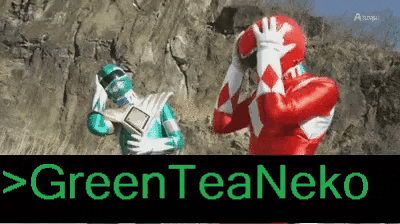 a green and red power ranger standing next to each other .
