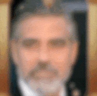 a blurry picture of a man with a beard and a hat