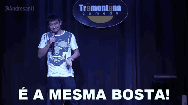 a man stands on stage in front of a sign for tramontana comedy