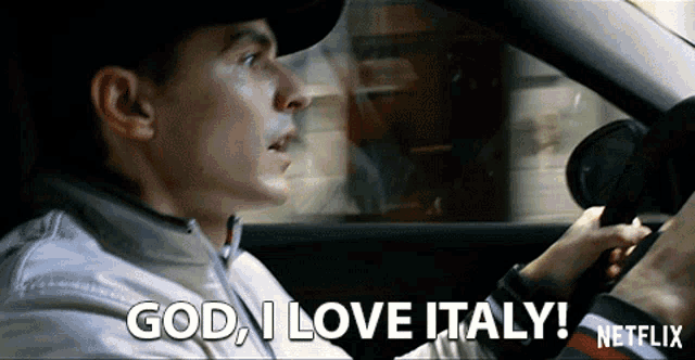 a man driving a car with the words god i love italy on the screen