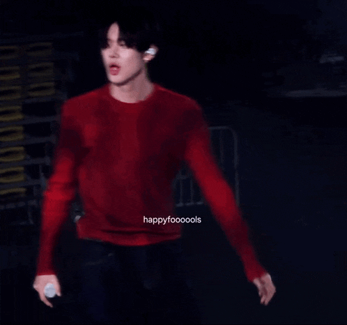a blurry photo of a man in a red shirt with happyfoooools written on the bottom