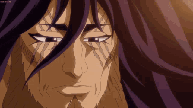 a close up of a man 's face with purple hair and a beard