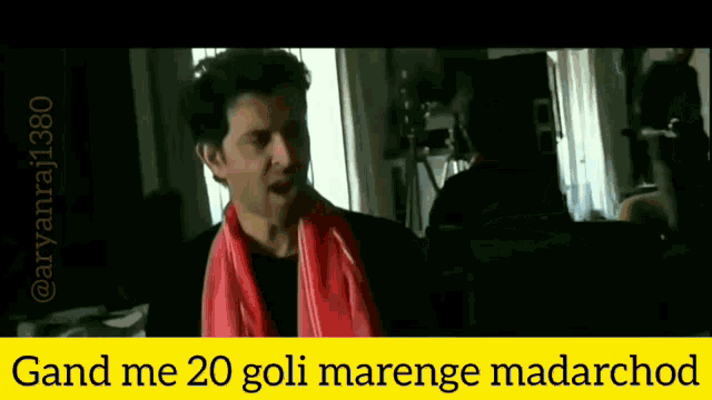 a man with a red scarf around his neck and the words gandi me 20 goli marenge madarchod