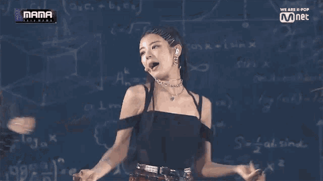 a woman stands in front of a chalkboard that says mama