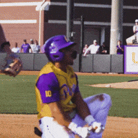 a baseball player wearing a yellow and purple jersey with the number 10 on the sleeve