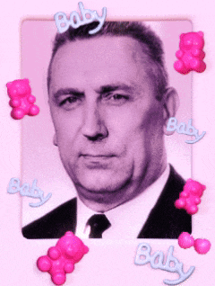 a man in a suit and tie is surrounded by pink gummy bears with the word baby written on them