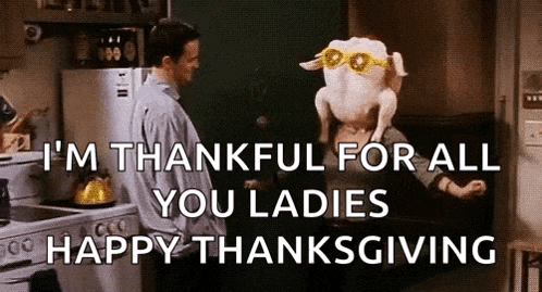 a man is standing next to a woman with a turkey head on her head .