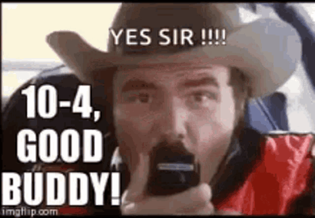 a man in a cowboy hat is holding a cell phone and saying `` yes sir !!! ''
