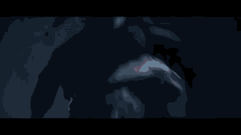 a blurry picture of a person in a dark room with smoke coming out of their mouth .