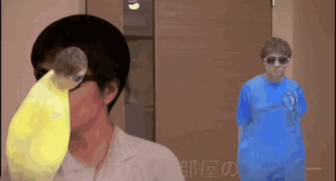 a man in a blue shirt stands next to a man in a yellow shirt
