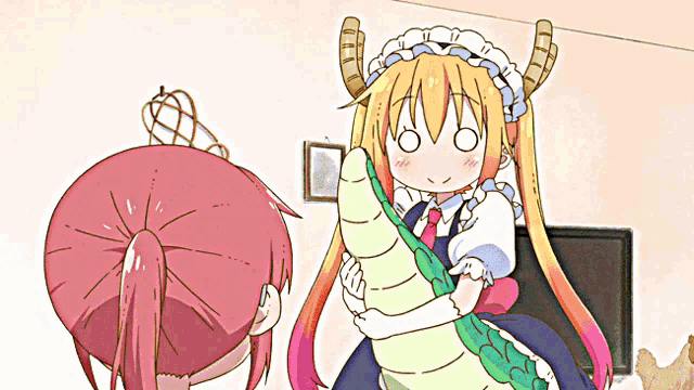 a girl with horns is holding a snake and giving a thumbs up sign