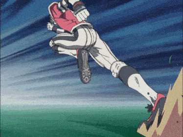 a baseball player is jumping in the air while wearing a red hoodie