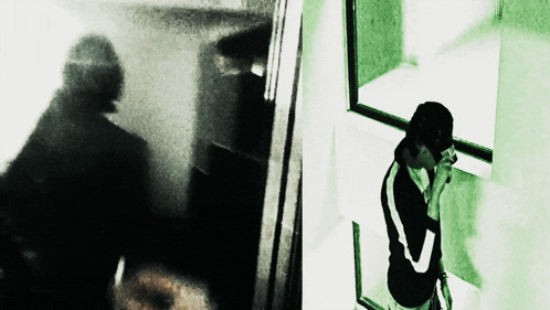 a man talking on a cell phone while looking out of a window