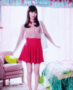 a girl in a red skirt is standing in a room