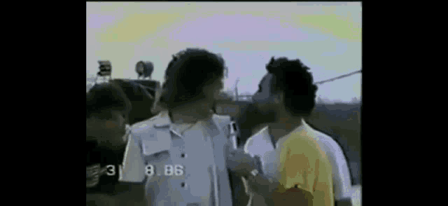 a group of men are standing next to each other in a video .