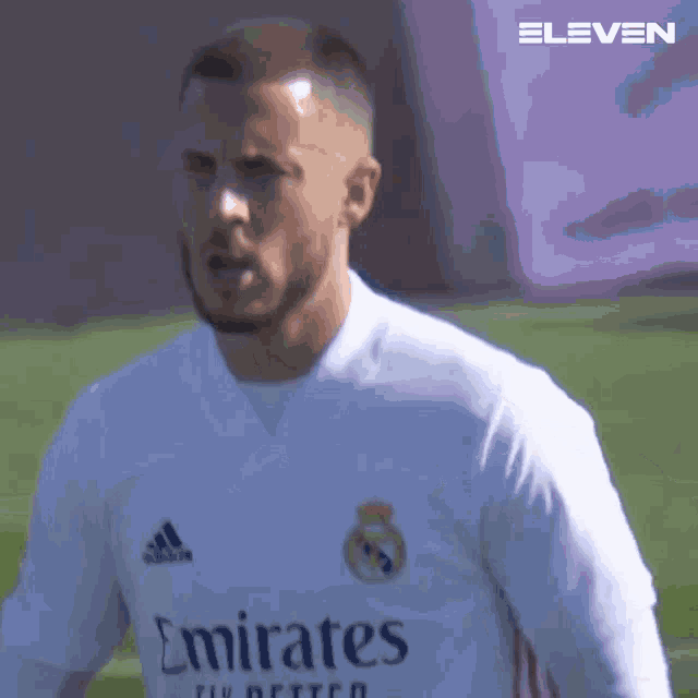 a man in a white adidas jersey is playing soccer .