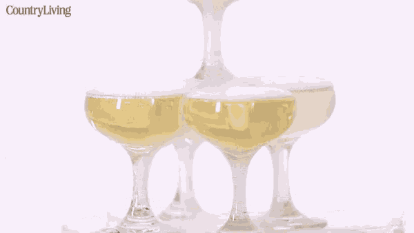 a stack of champagne glasses with a country living logo in the corner