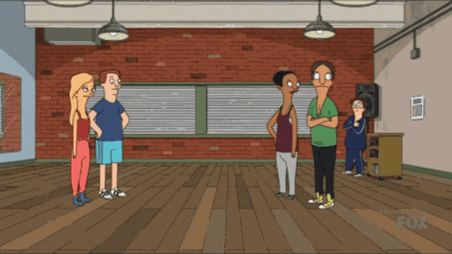 a group of people are standing in a room with a fox logo on the bottom right