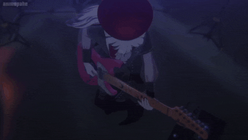 a girl is playing a pink electric guitar in a dark room .