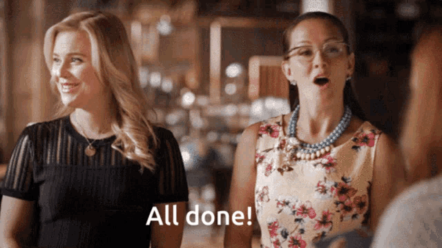 two women are standing next to each other and one of them is saying " all done "