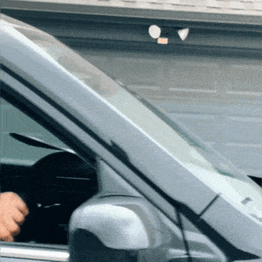 a car is parked in front of a garage
