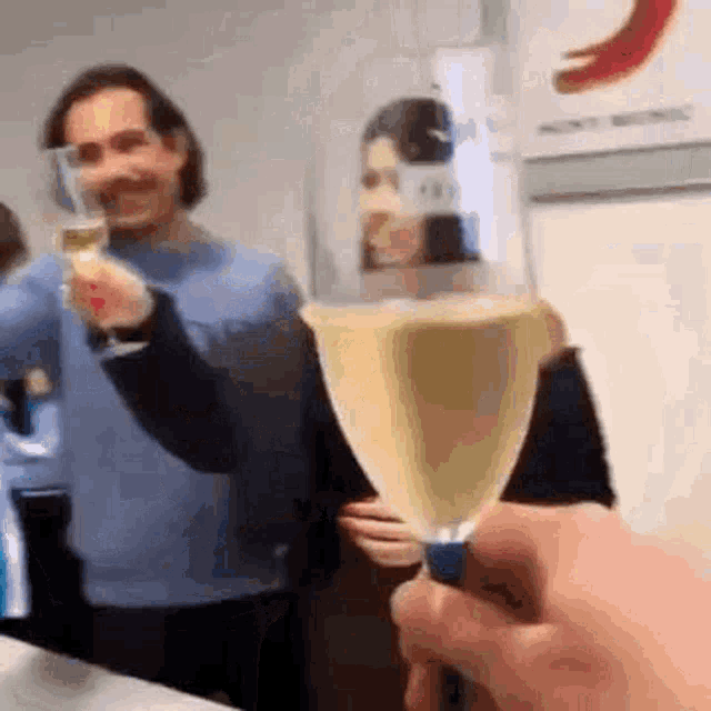 a group of people are toasting with champagne glasses .
