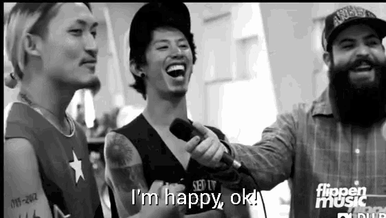 a man holding a microphone with the words i 'm happy ok