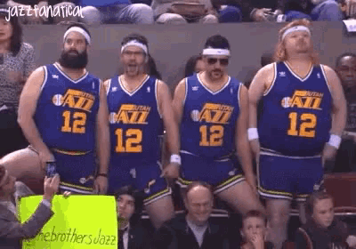a group of basketball players wearing utah jazz uniforms