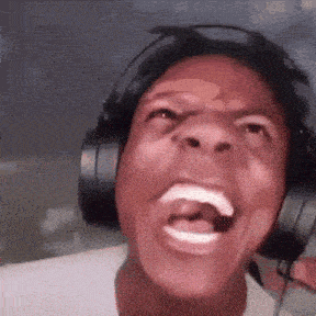 a man wearing headphones is screaming with his mouth open
