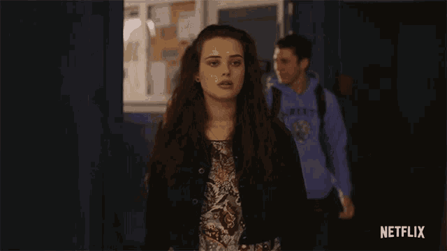 a girl standing in a hallway with netflix written on the bottom right